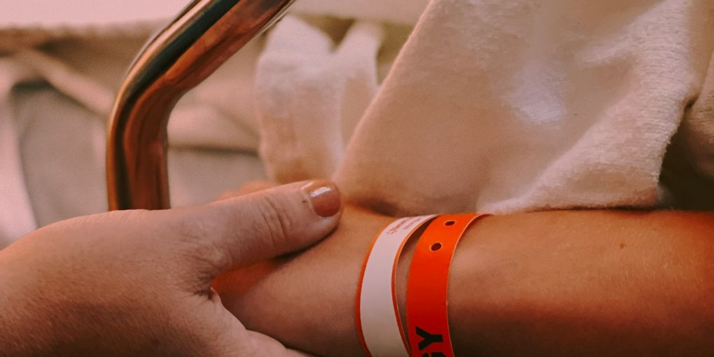 Hands holding in a hospital bed